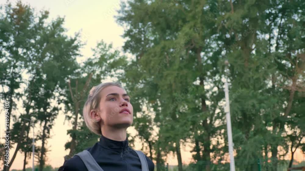 Beautiful female basketball player throwing ball, playing in park during daytime, morning Beautiful female basketball player throwing ball, playing in park during daytime, morning
