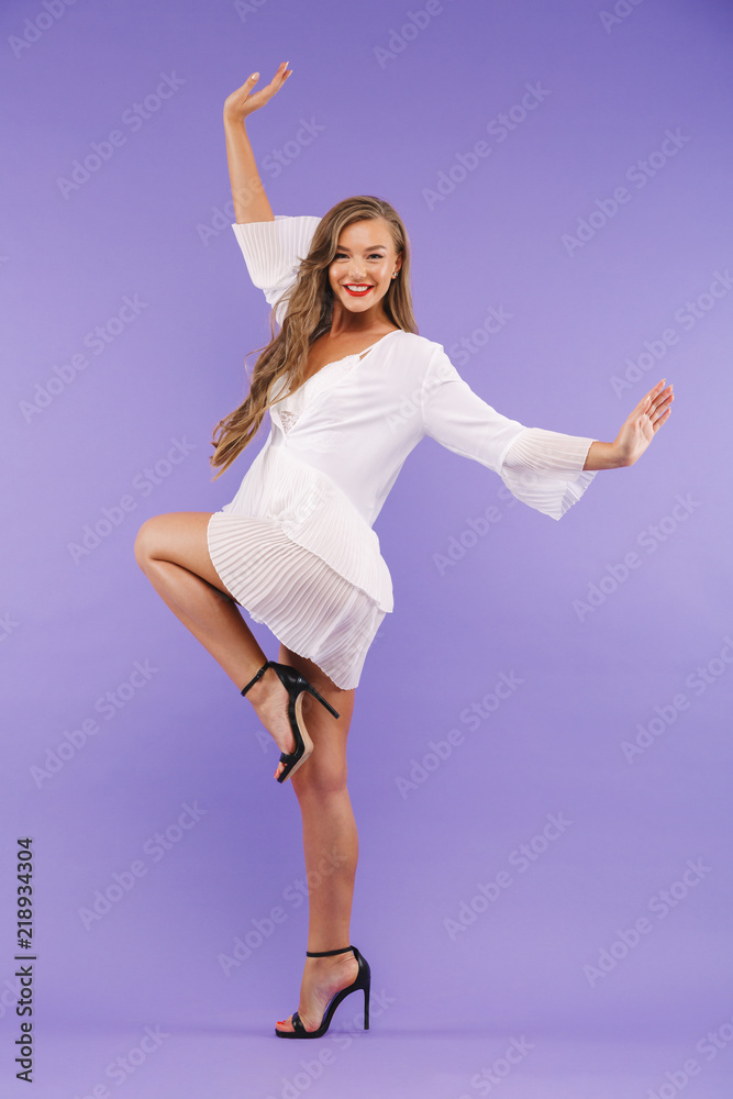 Fototapeta premium Full length portrait of a cheerful young woman