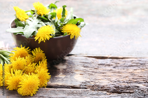 Fototapeta Naklejka Na Ścianę i Meble -  Yellow dandelions on wooden table