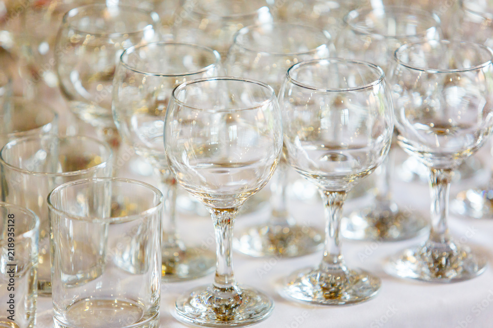 Empty wine glasses standing in row on table Empty wine glasses standing in row on table