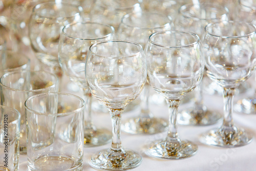 Empty wine glasses standing in row on table