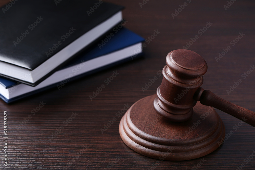 Judge gavel with books on wooden table