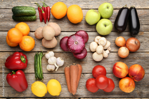 Ripe fruits and vegetables on grey wooden table