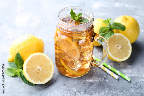 Ice tea in glass jar with lemon and mint leafs on wooden table © 5second