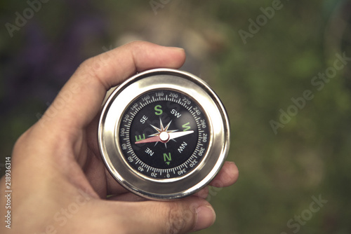 Hand holding magnetic compass. concept adventure of global travel.