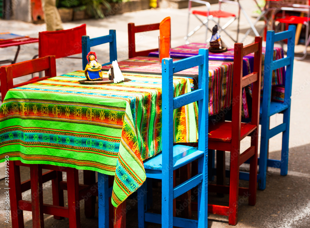 View of multi-colored chairs in a cafe on a city street, Buenos Aires, Argentina. With selective focus.