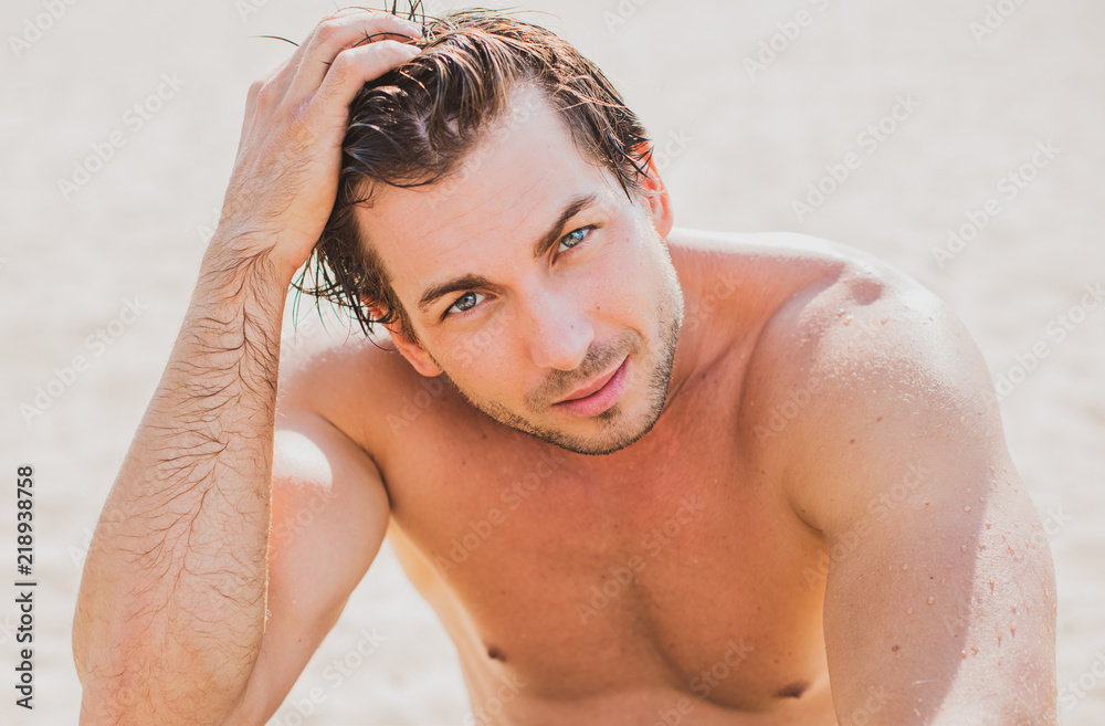 Man Body On Beach In Summer. Handsome Sexy Fit Male With Healthy Skin Sun Tan At Luxury Relax Spa Resort photo