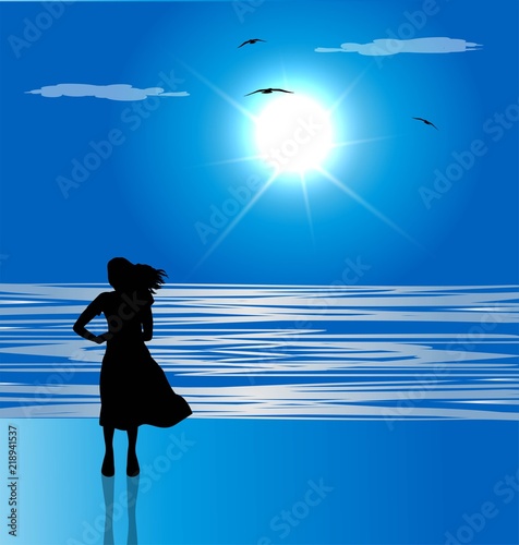 silhouette di donna sulla spiaggia che guarda il mare all'orizzonte