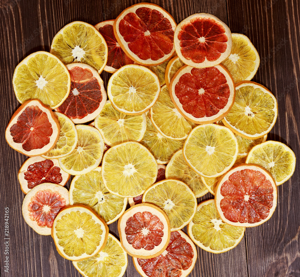 Dried oranges on a brown wooden background