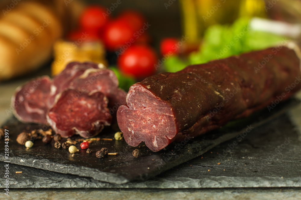 salami, salted meat jerky - sliced with slices (venison) . food background. Top view with copy space salami, salted meat jerky - sliced with slices (venison) . food background. Top view with copy space