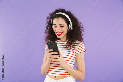 Portrait of a smiling young casual woman listening to music