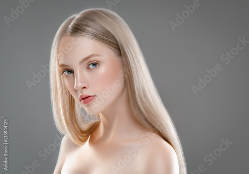 Beautiful Woman Face Portrait Beauty Skin Care Concept with long blonde hair  over gray background photo