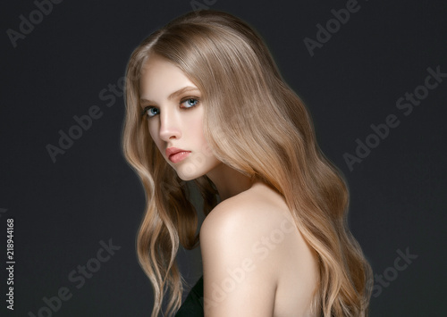 Beautiful Blonde Woman Beauty Model Girl with perfect makeup over black background.