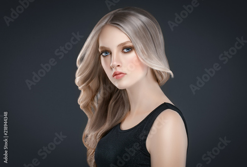 Beautiful Blonde Woman Beauty Model Girl over black background. © Utkamandarinka