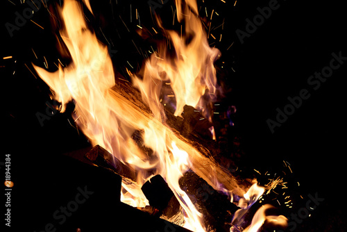 Fire flames on a black background. The fire burns on a black background. © zhekkka