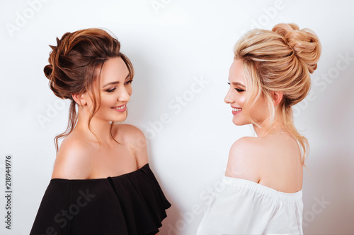studio portrait of two young beautiful women