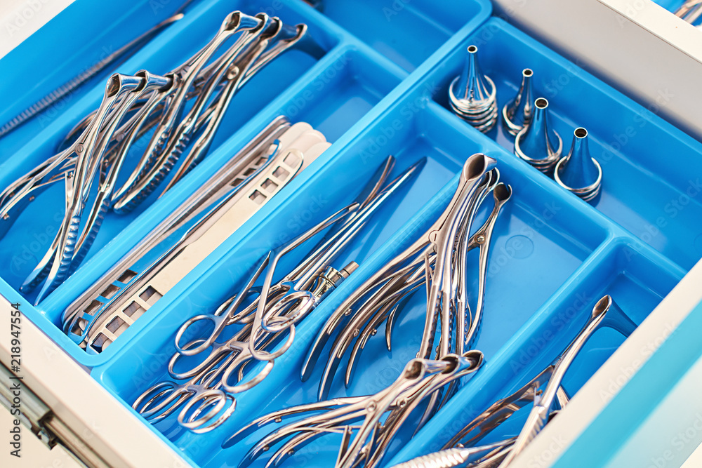 Otolaryngology medical instruments for ear, nose, throat, base of the skull treatment and surgery such as nasal speculums, forceps, tongue depressors, probes and tweezers in blue doctor box
