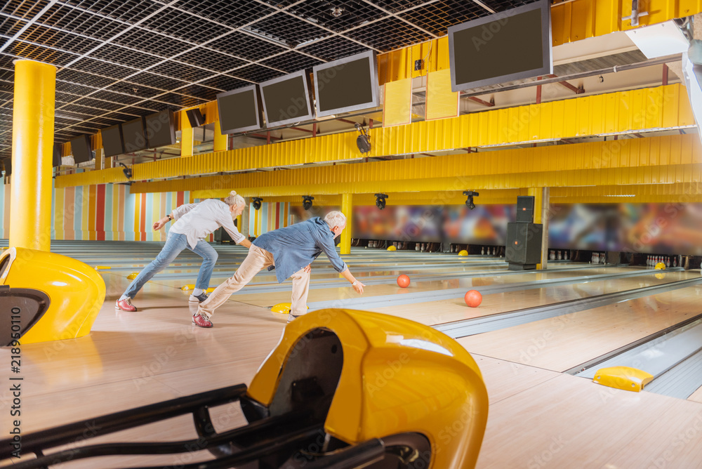 Who is better. Nice skilled men hitting balls while participating in the bowling competition Who is better. Nice skilled men hitting balls while participating in the bowling competition
