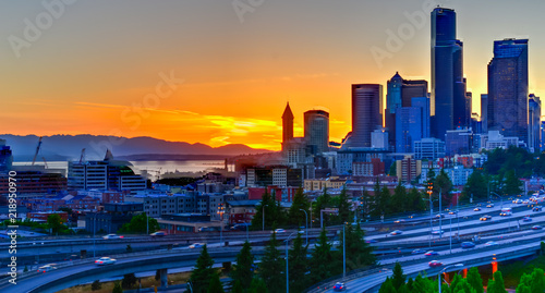 Panoramic view Seattle skylines and s-curved I-90, I-5 highway interchange traffic motion during sunset. Travel and transportation background, cityscape and high speed concept. View from Rizal Park photo