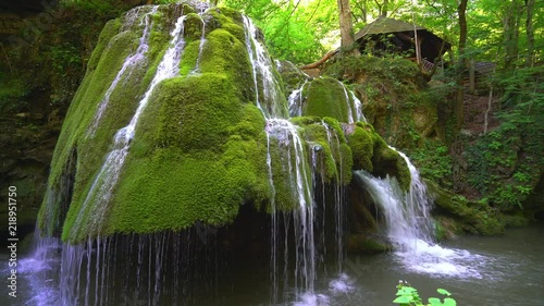 Beautiful unique Bigar Waterfall in Romania on the Edge of the Road passing through the carpatian Mountains photo