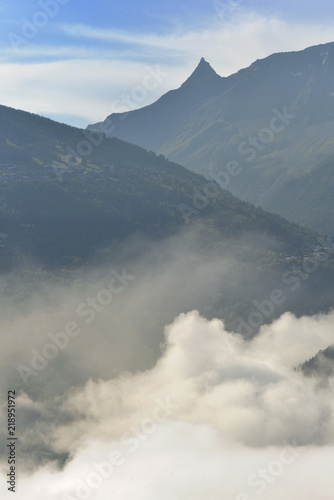 clouds in a valley overlooking by peak mountain 