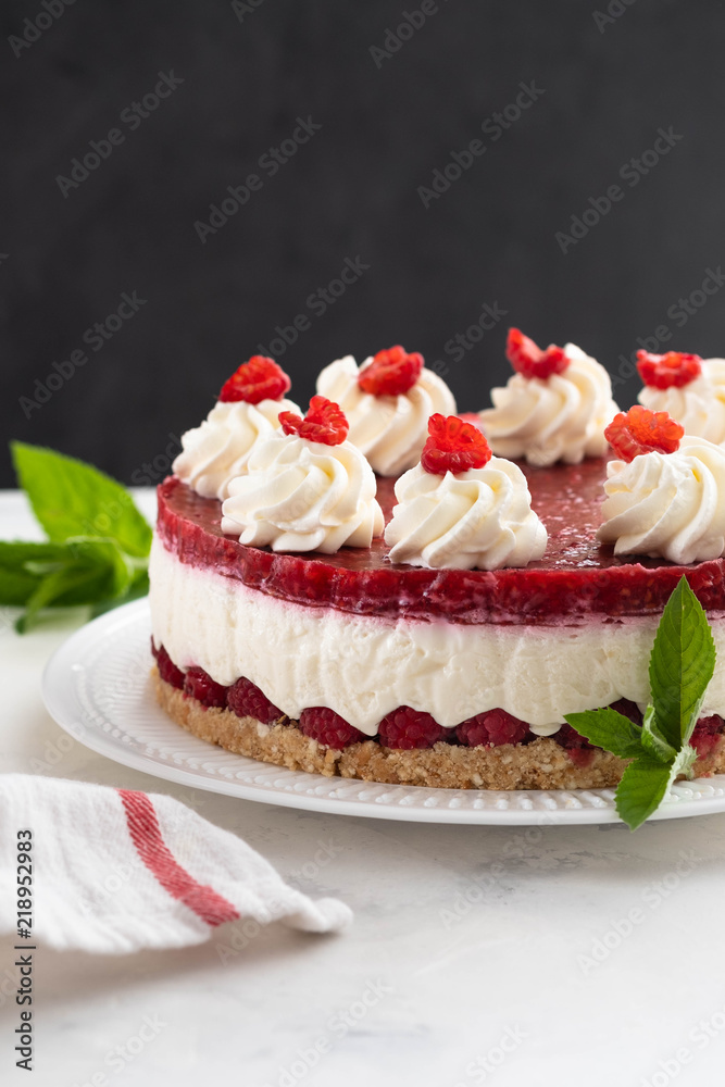 Raspberry cream mousse cake no baked cheesecake on white background. Copy space. Raspberry cream mousse cake no baked cheesecake on white background. Copy space.