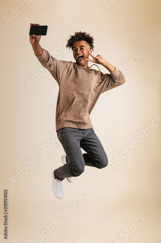 Full length portrait of a cheerful young afro american man