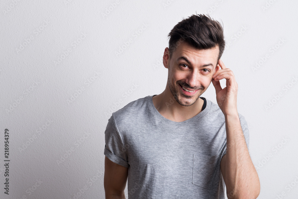 Portrait of a young cheerful man in a studio. Copy space. Portrait of a young cheerful man in a studio. Copy space.