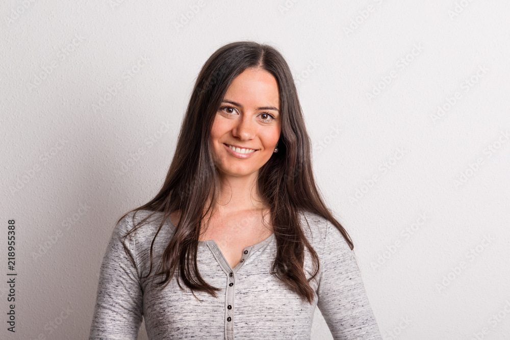 Obraz premium Portrait of a young beautiful woman in studio on a white background.