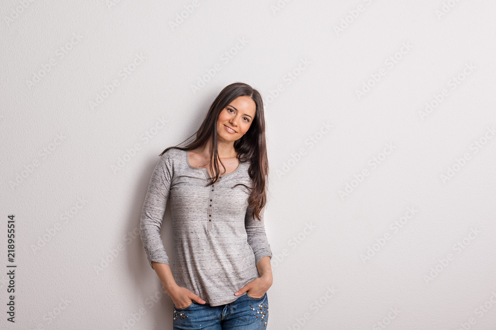 Portrait of a young beautiful woman in studio on a white background. Portrait of a young beautiful woman in studio on a white background.
