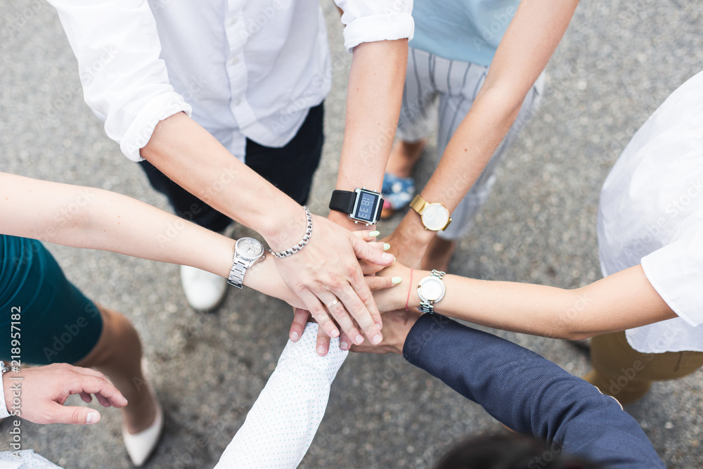 business, people and teamwork concept - smiling group of businesspeople standing in circle and putting hands on top of each other business, people and teamwork concept - smiling group of businesspeople standing in circle and putting hands on top of each other