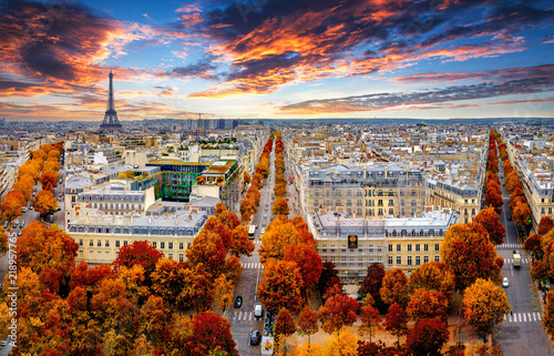 Aerial view of Paris in late autumn at sunset.Red and orange colored street trees. Eiffel Tower in the background. Paris, France
