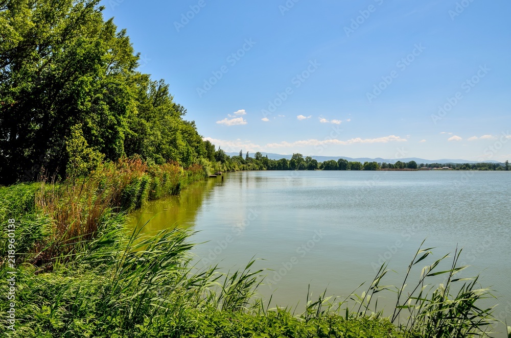 Obraz premium Daily springtime landscape. Beautiful lake with mountains in the background.
