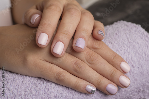 Beautiful hands with pink manicure. Copy space