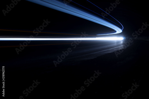 Abstract and interesting art concentration of blue light trails in a road tunnel at night