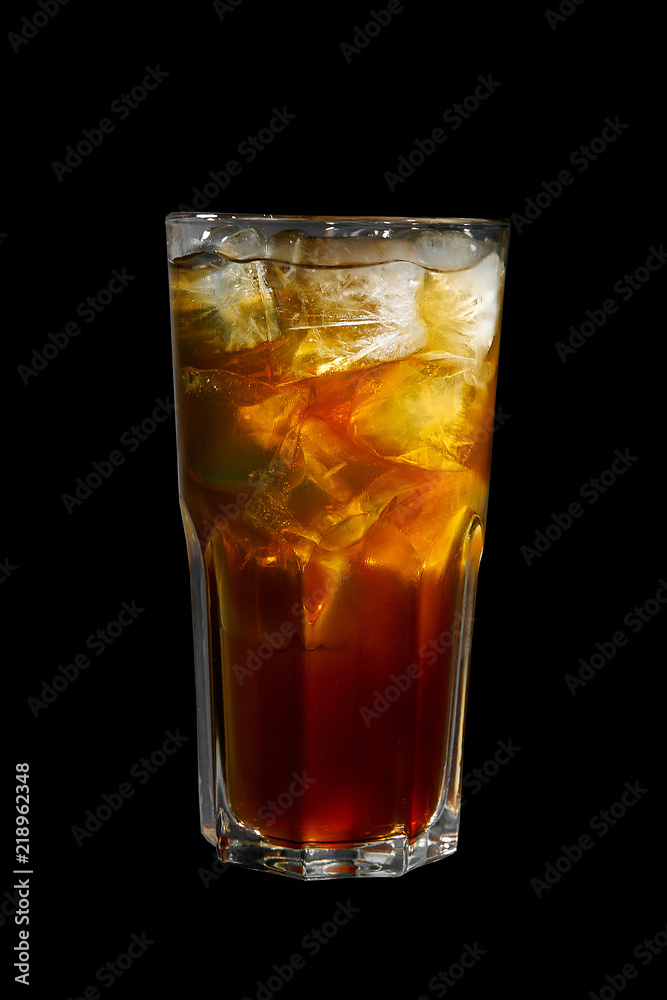 One-color, red, brown, transparent cocktail with ice cubes. Isolated black background. Side view. Drink in a glass glass for the menu restaurant, bar, cafe One-color, red, brown, transparent cocktail with ice cubes. Isolated black background. Side view. Drink in a glass glass for the menu restaurant, bar, cafe