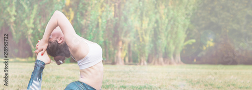 Slim young woman practicing yoga in nature. standing in poses