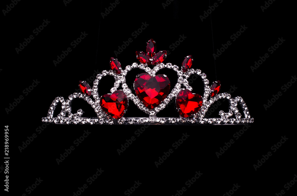 silver diadem with hearts, rubies and diamonds isolated on black