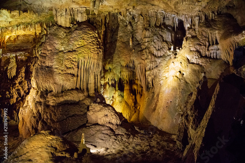 wall of karst cave is highlighted by yellow lantern