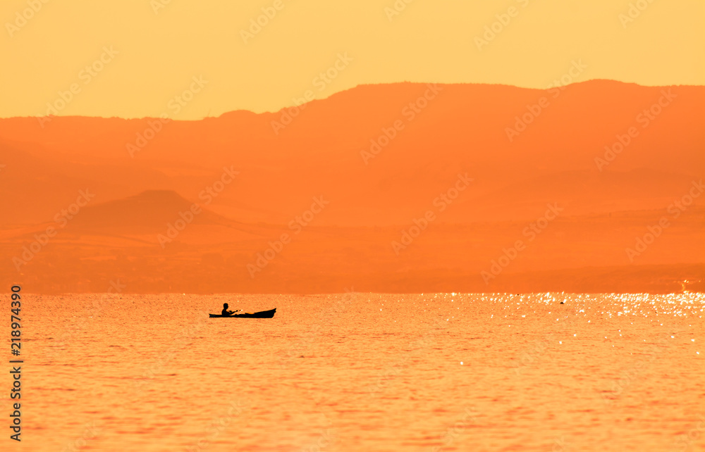 kayak sailing at sunset