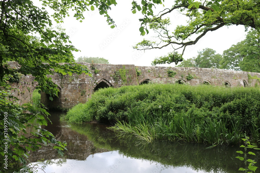 Old English stone Georgian bridge. An old stone bridge near a river in England. Old English stone Georgian bridge. An old stone bridge near a river in England.
