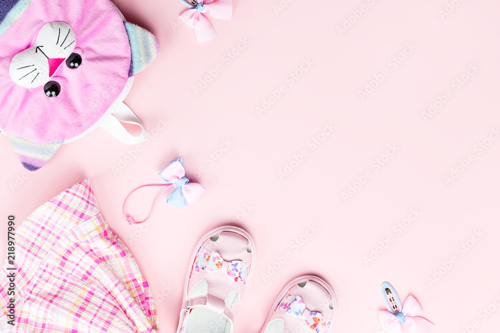 Little girl clothes and accessories on pink background. Little girl clothes and accessories on pink background.