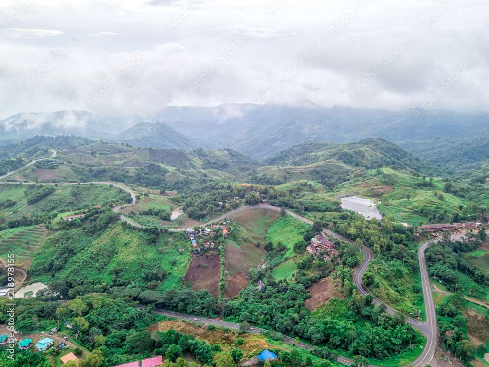 Beautiful mountain scenery rainy weather. Aerial view of rainforest with mist and sunlight in the morning, view of natural high mountain with cloud and sky. Amazing nature landscape. Beautiful mountain scenery rainy weather. Aerial view of rainforest with mist and sunlight in the morning, view of natural high mountain with cloud and sky. Amazing nature landscape.
