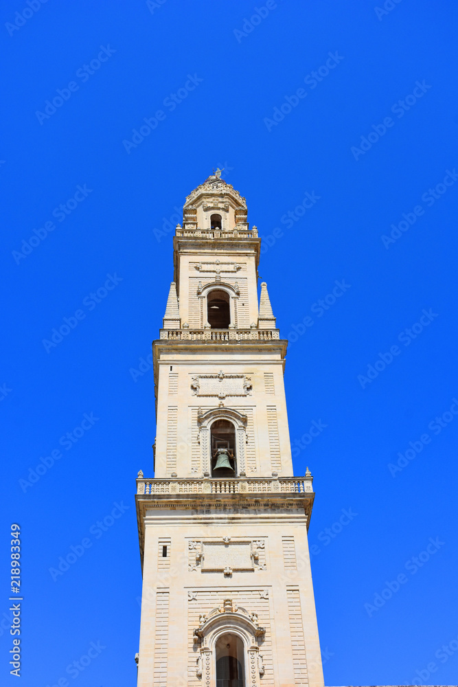 Italy, Lecce, Duomo square, in Baroque style, bell tower, view and architectural details. Italy, Lecce, Duomo square, in Baroque style, bell tower, view and architectural details.