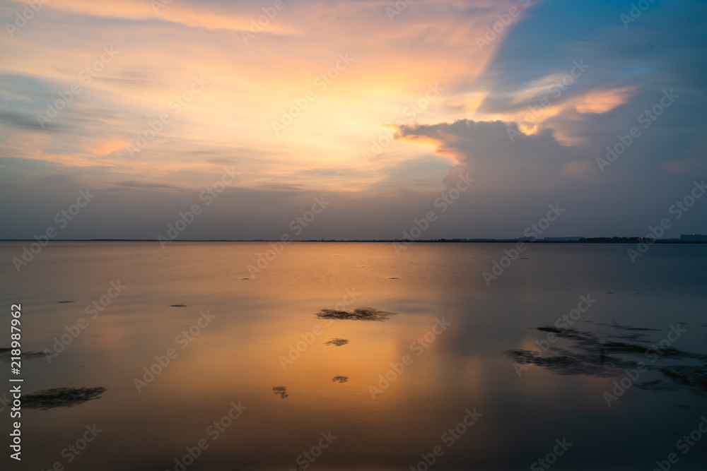 Sunset over the lake, golden light and clouds
