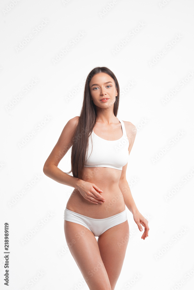 Slim young woman in underwear on white background Slim young woman in underwear on white background