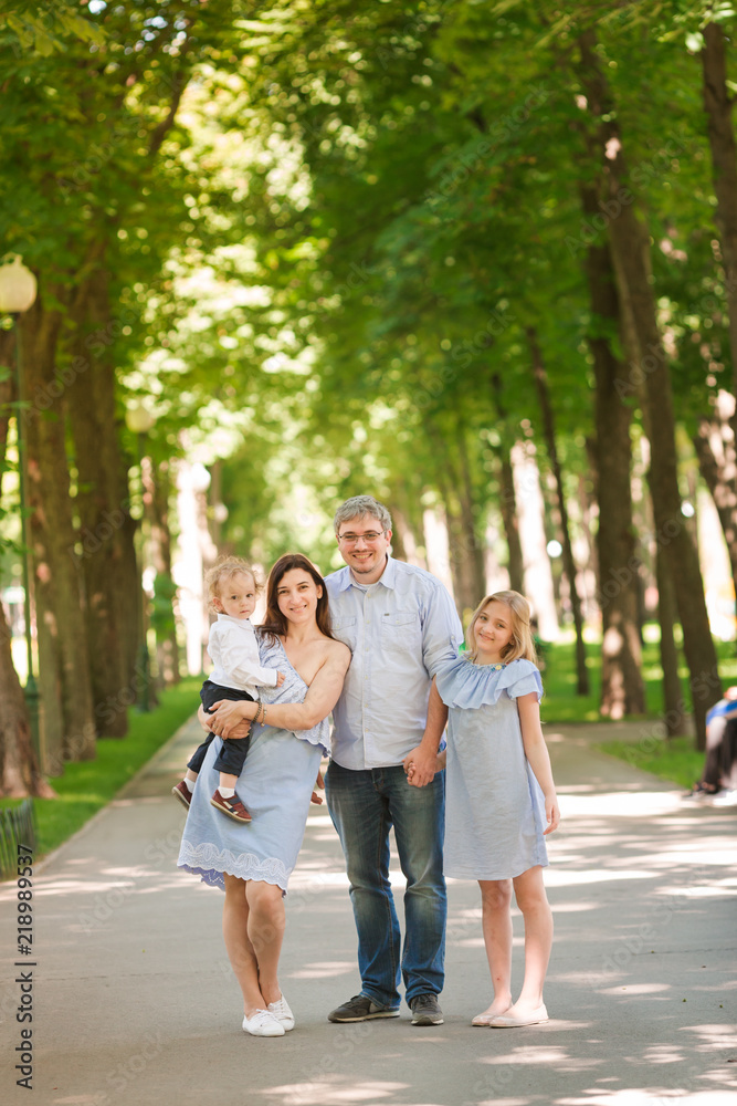 Happy family with two kids in the park