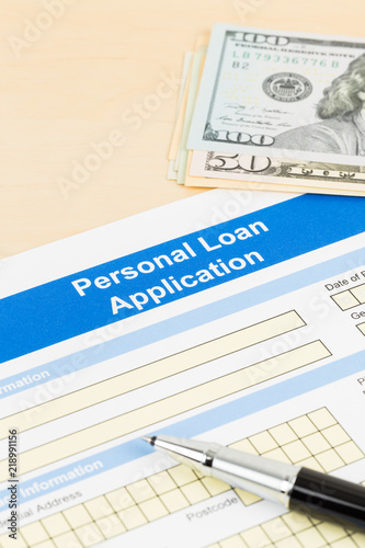 Personal loan application form with dollar money banknote, and pen