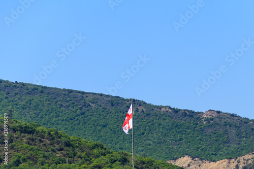 Georgian flag on a background of the Caucasus mountains