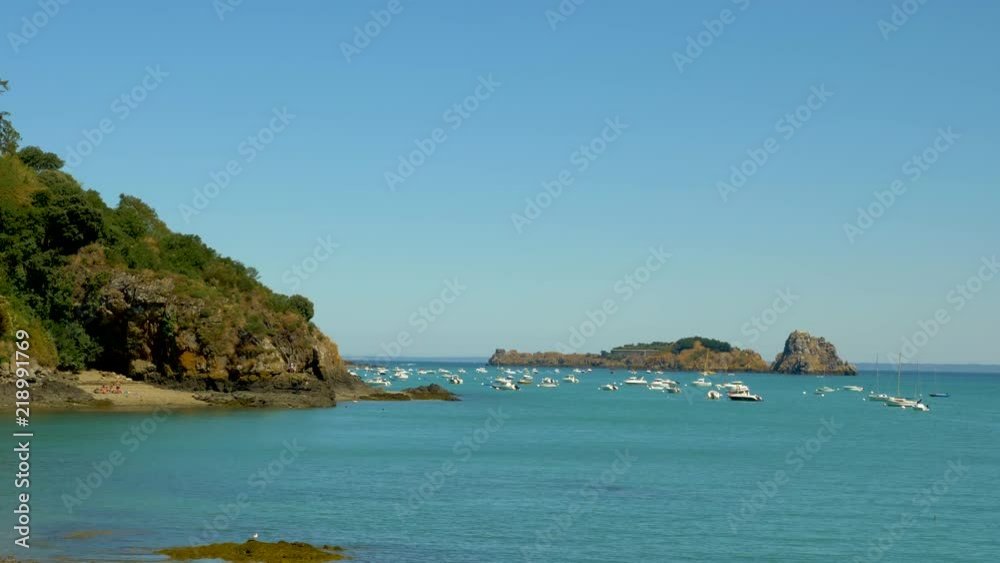 Beautiful landscape at the sea of boats in the water next to the cliff during a sunny day in summer Beautiful landscape at the sea of boats in the water next to the cliff during a sunny day in summer